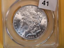 CACG 1884-O Morgan Dollar in Mint State 64