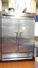 True T-49F vertical stainless 2 door reach-in freezer with wheels in use