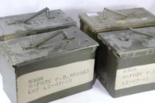 Four green metal 50 cal ammo boxes.