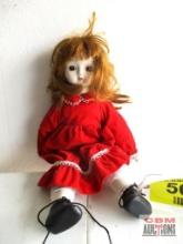 Doll with Solid Red Dress and White Trim Wearing Black Shoes