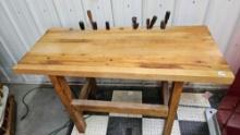 wooden work table with assorted tools