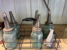 Crate of glass jars with oil spouts