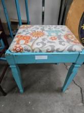 Teal bench with cloth cushion with elephante on it