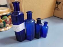 4 Blue glass bottles