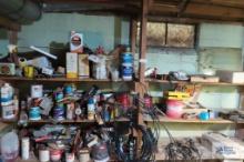 painting supplies, car parts and etc on wooden shelving in basement