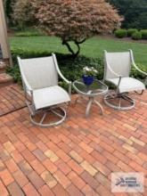 Four spring chairs and two glass top outdoor end tables made by Winston