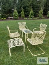 Four Brown Jordan outdoor chairs with footstool and one glass top end table. model is Tamiami