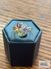 Gold colored ring with floral shaped multicolored gemstones and clear gemstones, marked 10K, 2.3 G.