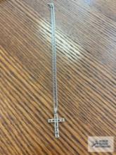 Silver colored cross pendant, cross has markings on silver color chain,...3.8 G. Description provide