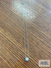 Silver colored necklace with clear gemstone pendant, marked 925, 2.0 G. Description provided by