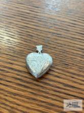 Silver colored heart-shaped locket, marked 925, 8.2 G. Description provided by seller.