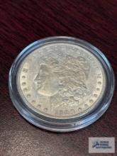 1900 Morgan one dollar coin in plastic case