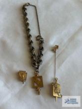 Gold colored bracelet, no markings with one sorority charm, marked 10K and other college pendant,