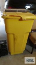 Yellow roll about trash can. lid has damage