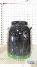 Antique black crock with green line on bottom