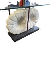 White Stone Sculpture with Red Poles and Glass Top on Black Base