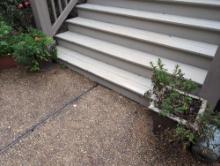 (BY) PAIR OF HARD PLASTIC BASKET WEAVE PLANTERS WITH FLOWERS. DOES SHOW SOME WEAR. THEY MEASURE