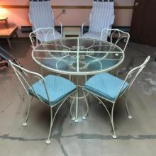 Wrought Iron and Glass Patio Table and Chairs in Basement of Home