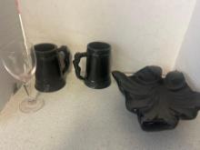 Black ceramic mugs and leaf dish