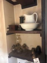 contents of shelf. brass bells oil lamps and misc home decor