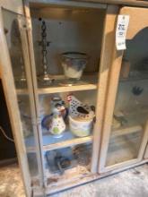 cabinet full of antiques and collectibles